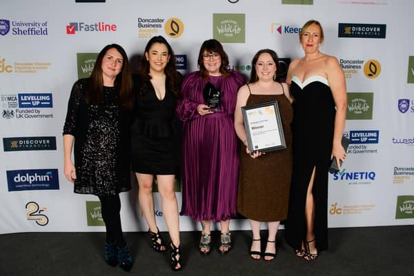 Communications team, charity team and Rhian Morris (far right) receive their award