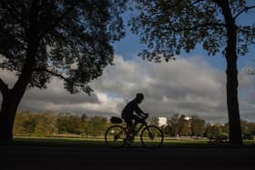 A cyclist in a park - photo by Angus Murray