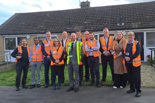 Visitors outside improved homes in Maltby