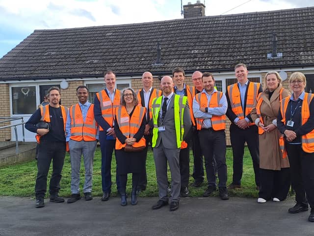 Visitors outside improved homes in Maltby
