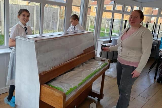 Cllr Brookes helping to decorate her old piano