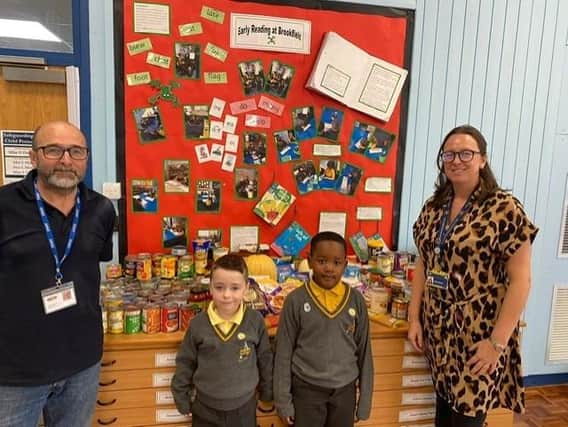 Paul  Senior from Swinton Lock Foodbank (left) and  Lauren Moore, inclusion lead at Brookfield (right) with two Brookfield Junior Academy pupils