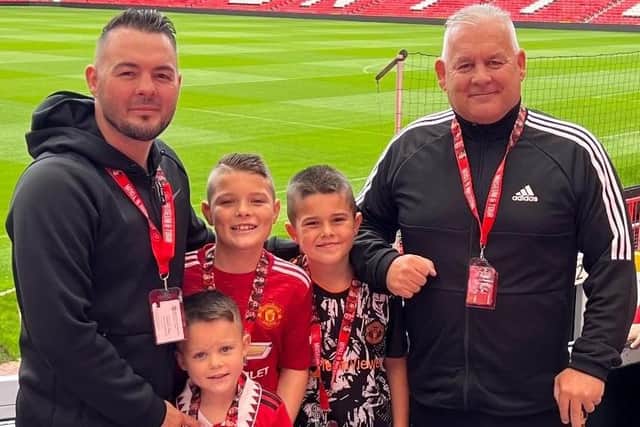 Josh Wale, his dad Mick and kids at Old Trafford, home of Manchester United