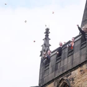 The  annual bread-throwing from the spire at All Saints Church, Wath. The tradition commemorates the 1810 will of clergyman Thomas Tuke, who bequeathed money for bread distribution for the poor.