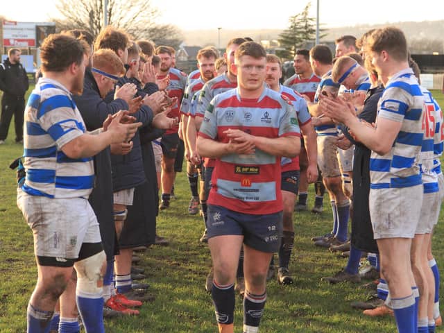 Harry Dunne leads the Titans team line after his 100th appearance for the club. Picture by GARETH SIDDONS