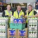 Jonathan Dixon, vice president  of sales at Arla, Simon Millard,  director of food at FareShare, and Andrew Shaw, supply chain director for UK and Ireland at Nestlé at FareShare's distribution centre in Wombwell.Photo credit: Dominic Lipinski/PA Wire