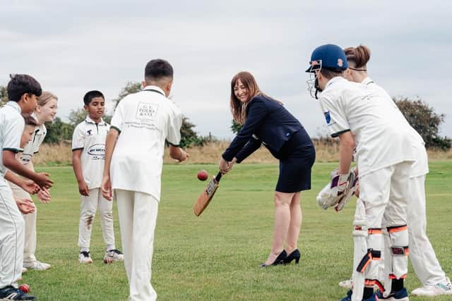 TAKING A SWING: Sales advisor Philippa Ingram at the bat (Wes Webster Photography)