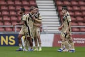 Josh Benson accepts the congratulations of his Rotherham United teammates after his goal at Northampton Town. Picture: Jim Brailsford