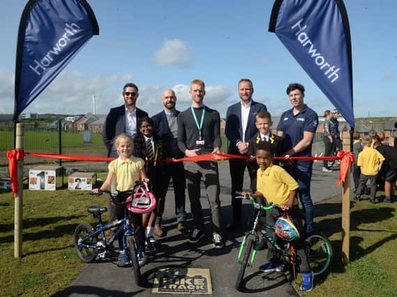 A new bike track was officially opened at Waverley recently by Former British professional track and road bicycle racer and active travel commissioner Ed Clancy (centre). He was watched by pupils of Waverley Junior Academy and, from left to right: development manager at Harworth Pete Massie, project director James Connelly, regional director for Yorkshire and central Ed Catchpole and national facilities development manager for British Cycling Manus Twomey.