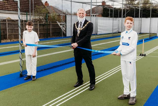 The Mayor of Rotherham cuts the tape watched by two Anston junior cricketers