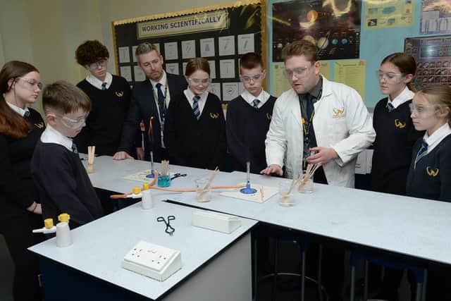 Students in a science class with teacher and ex pupil Richard Cliffe and head teacher Phil Davis.