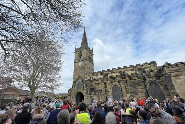 Tradition: Crowds gathered at Wath Parish Church for the traditional bun throwing from the top of the church, which took place as the clock struck 12 noon on Saturday during Wath Festival