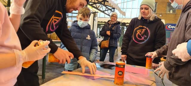 Young people involved with Big History, Bright Future take part in a graffiti workshop at Rotherham's Uplift Skate and Art Festival (Photo: Art of Protest)