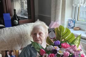 Betty with her flowers and card from the King