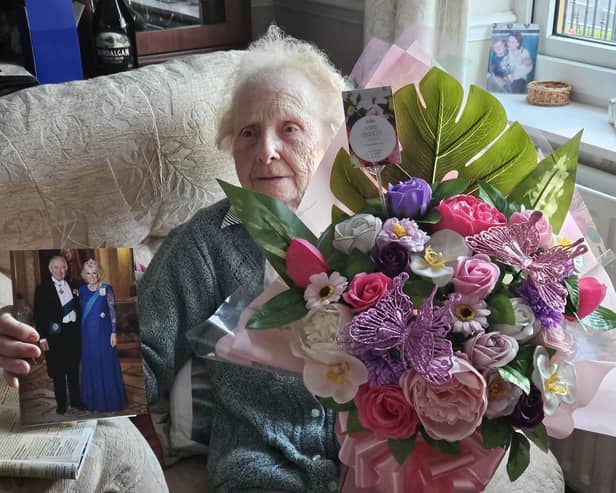 Betty with her flowers and card from the King
