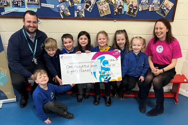 Headteacher Scott Holmes, Theo, Hudson and Tobias from the Early Years Foundation Service, Poppy from year 1, Alana from year 1, Eve from year 2 and Aariya from year 3, and Suzanne Rutter, charity engagement and development manager at Rotherham Hospital and Community Charity