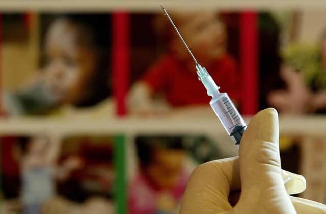 A nurse handles a syringe at a medical centre (photo = PA)